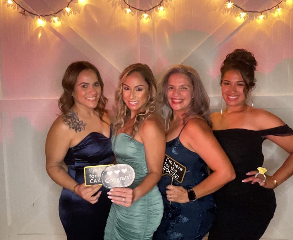 Wedding guests with custom props at the booth