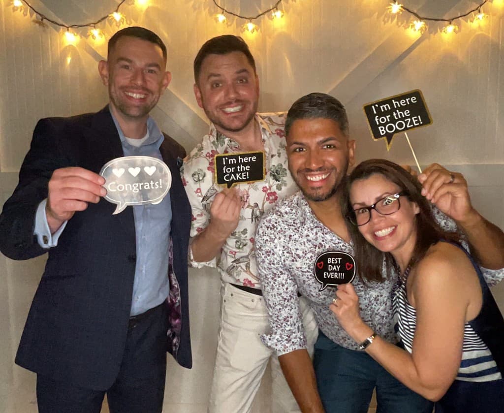 Wedding guests with celebration props at the photo booth