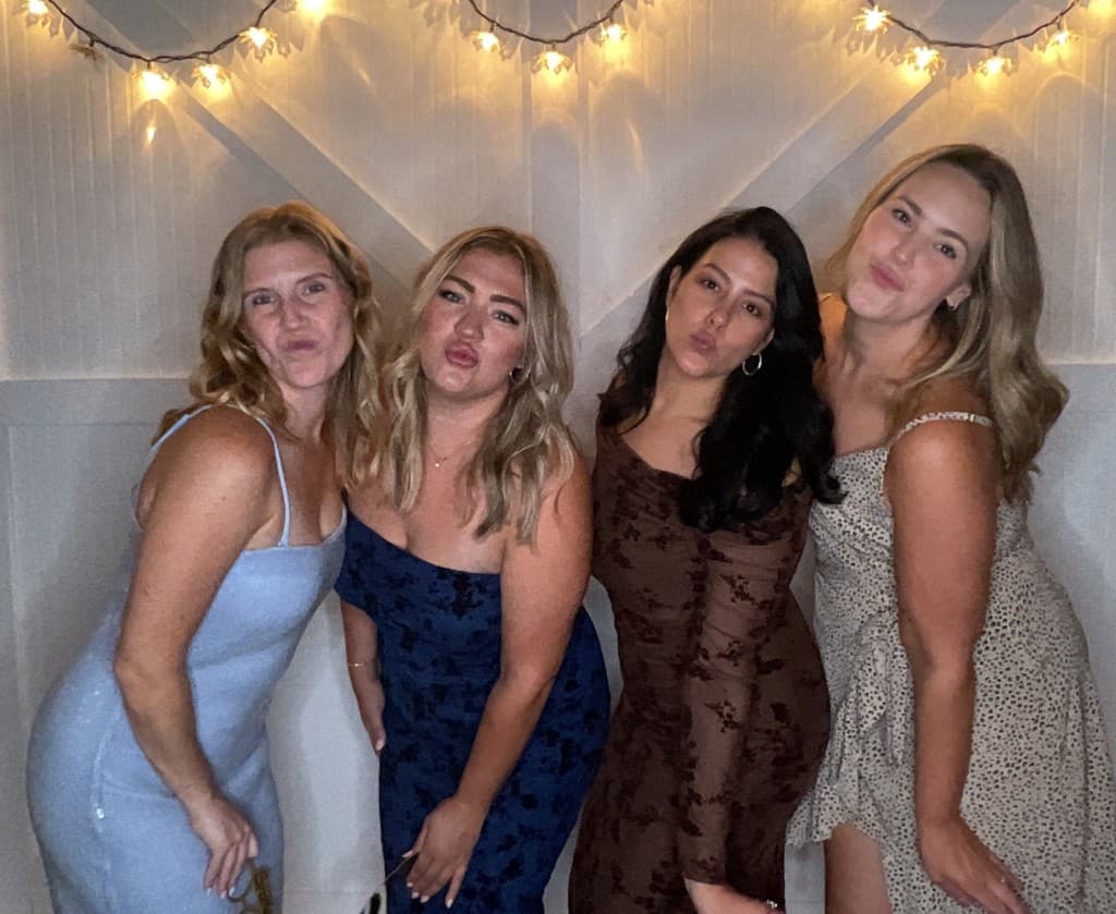 Wedding guests posing at the photo booth